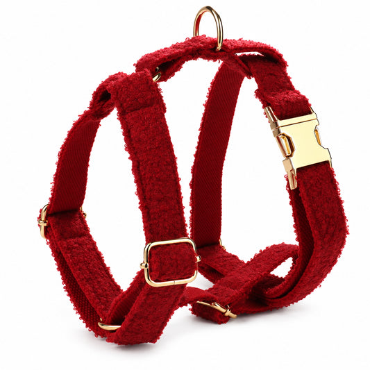 Red teddy fleece dog harness with adjustable straps, gold-tone buckles and D-ring on a white background.