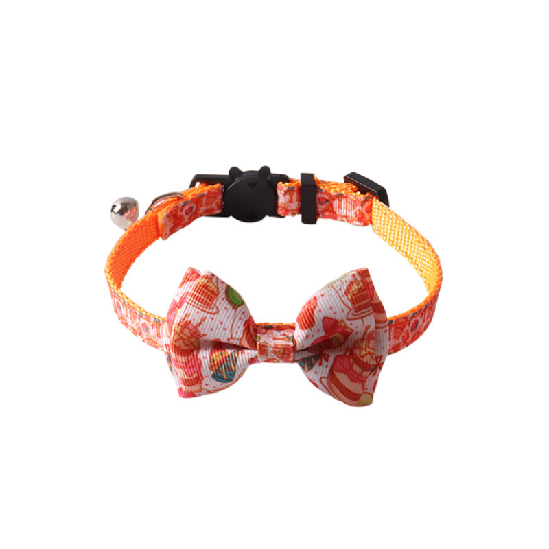 Birthday party orange cat collar with removable bow tie on white background