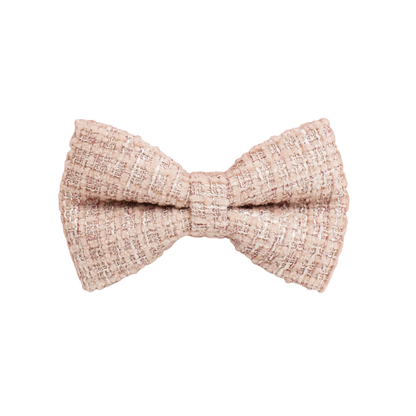 Close-up of a Bling Fuzzie blush pink tweed detachable dog bow tie, showing the soft woven texture with pink and white thread details on a white background