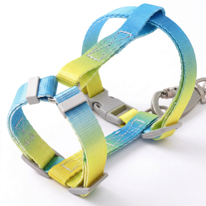 Close-up of a Bling Fuzzie blue yellow escape-proof H-style step-in cat harness, showing the adjustable straps, dual-lock buckle, and zinc alloy clasp on a white background