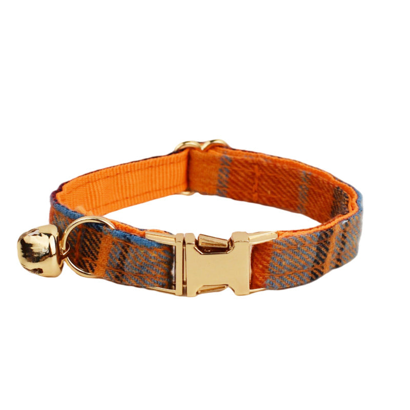 Orange plaid cat collar with adjustable strap, gold-tone buckle and matching bell on white background