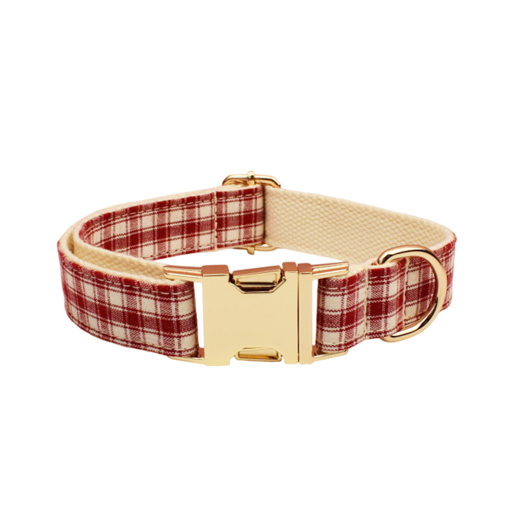 Adjustable red and cream plaid dog collar featuring a gold metal buckle, D-ring and cream-colored lining.