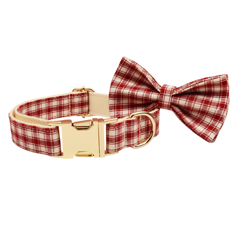Red and cream plaid adjustable dog collar with matching bow tie, gold buckle and D-ring on a white background.