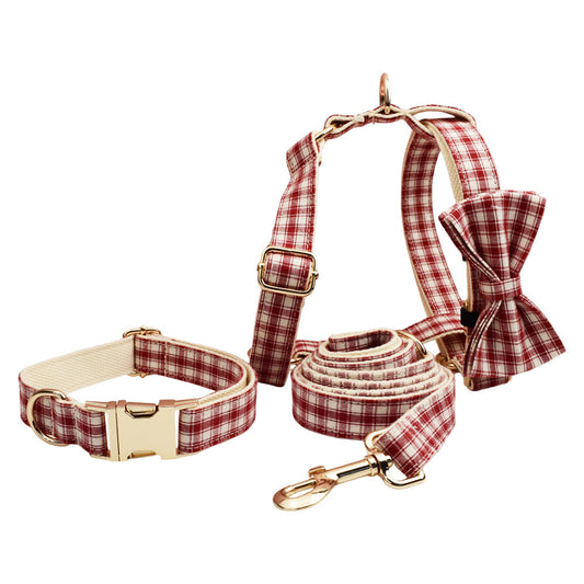 Complete red and cream plaid dog accessory set including adjustable harness, collar, bow tie and matching leash with gold hardware.