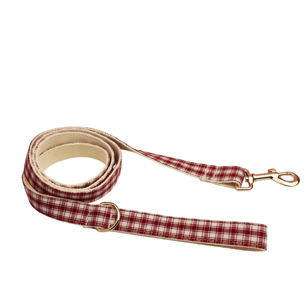 Red and cream plaid dog leash with gold metal clasp and matching fabric handle on a white background.