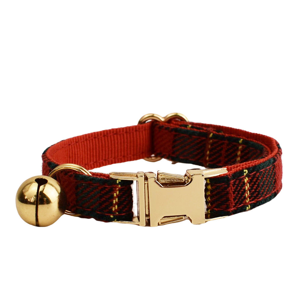 Red tartan plaid cat collar with adjustable strap, gold-tone buckle and matching bell on white background