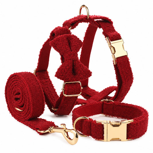 Complete red teddy fleece dog walking set with adjustable harness, collar, detachable bow tie and matching leash with gold-tone hardware.